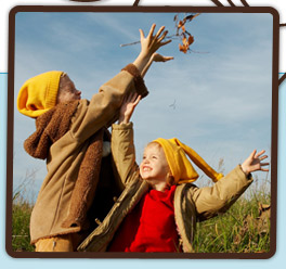 children and falling leaves